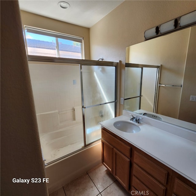 bathroom featuring shower / bath combination with glass door, vanity, and tile patterned flooring