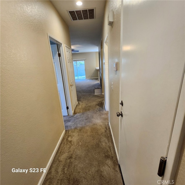 hallway with dark carpet