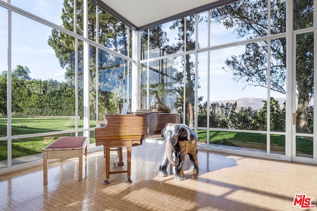 sunroom / solarium featuring a mountain view