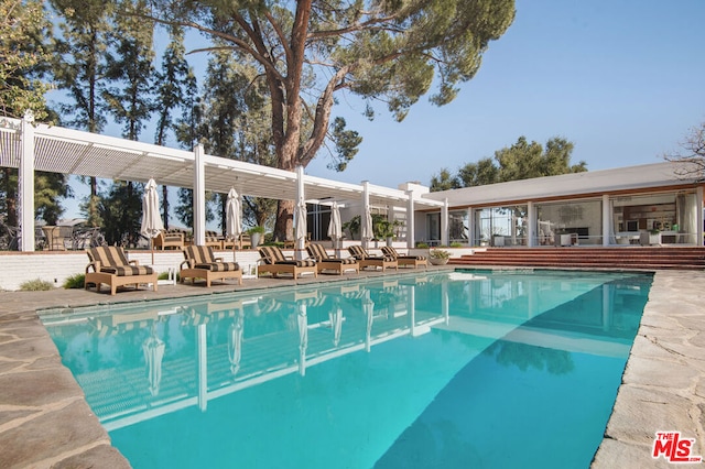 view of swimming pool with a pergola and a patio