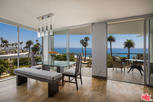 sunroom / solarium featuring a water view