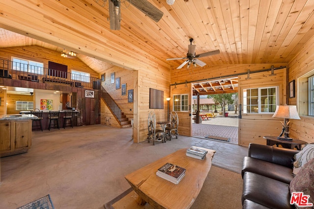 living room featuring high vaulted ceiling, wood walls, and wooden ceiling