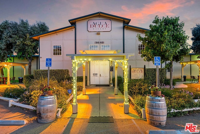 view of outdoor building at dusk