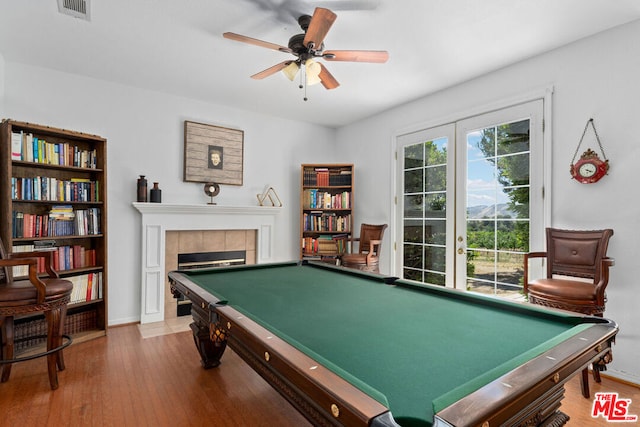 game room with pool table, a fireplace, ceiling fan, and hardwood / wood-style flooring