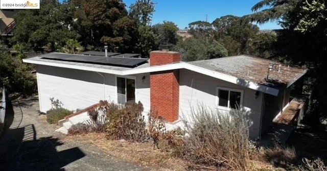 back of house with solar panels