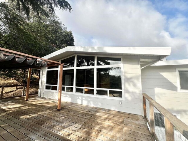 wooden deck featuring a sunroom