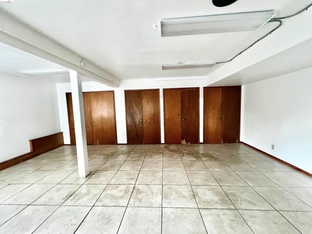 basement featuring light tile patterned flooring