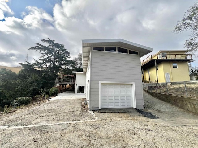 view of home's exterior featuring a deck and a garage