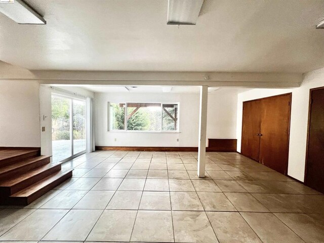 unfurnished living room with light tile patterned flooring