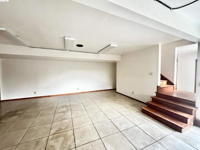 basement featuring light tile patterned flooring