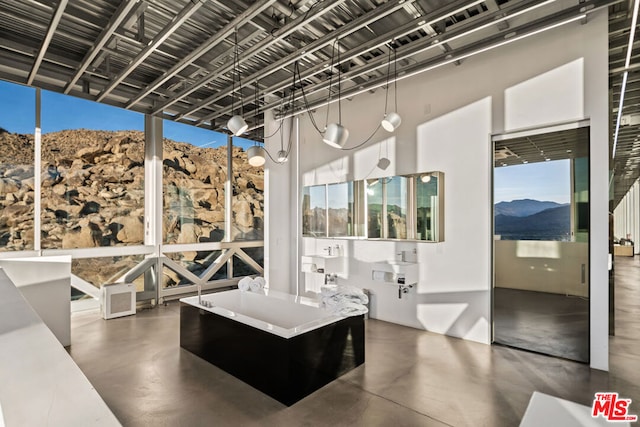 bathroom with a mountain view and concrete flooring