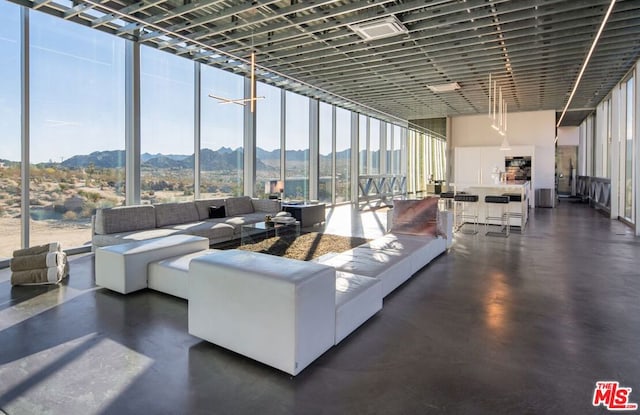 living room with a mountain view and a wall of windows