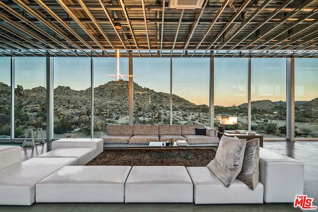 interior space featuring a wall of windows, concrete flooring, and a wealth of natural light