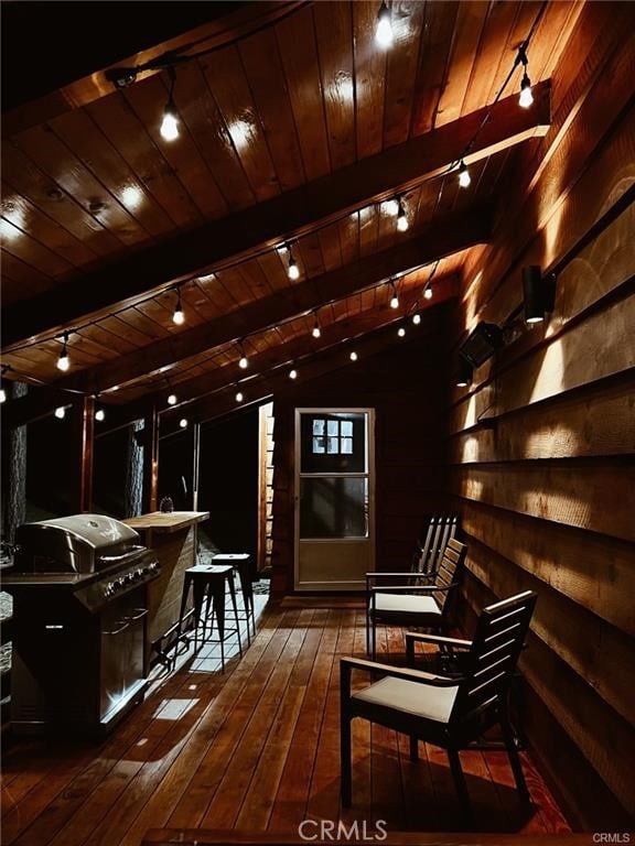 bar featuring wood walls, wood ceiling, lofted ceiling with beams, and dark hardwood / wood-style flooring