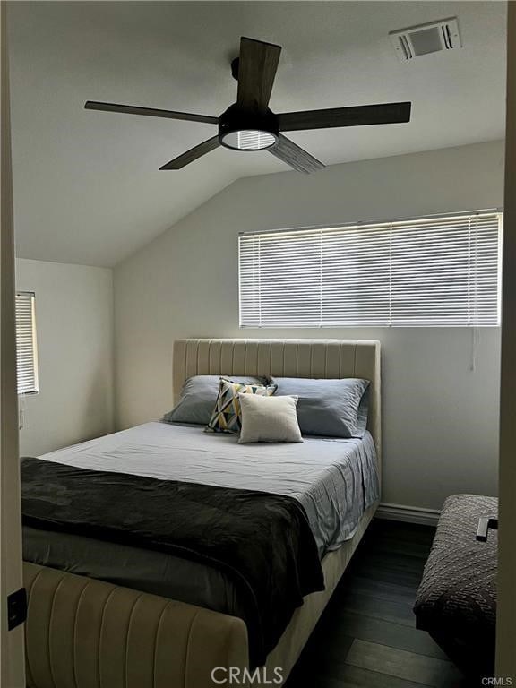 bedroom featuring ceiling fan, lofted ceiling, and dark hardwood / wood-style floors