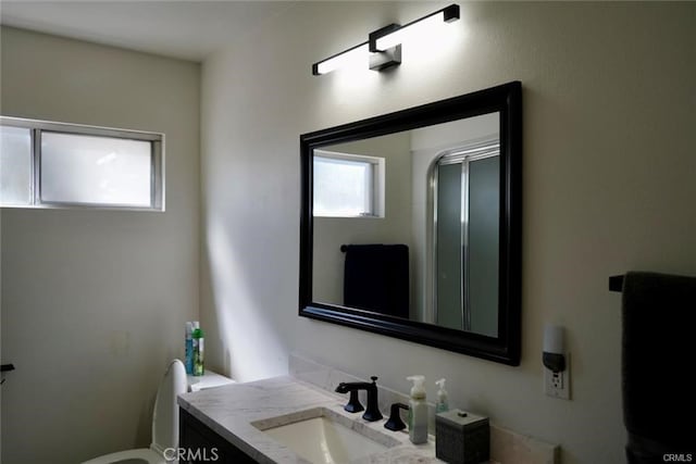 bathroom featuring vanity and toilet