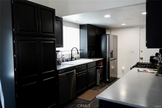 kitchen with dark hardwood / wood-style floors, black dishwasher, sink, and stainless steel fridge with ice dispenser