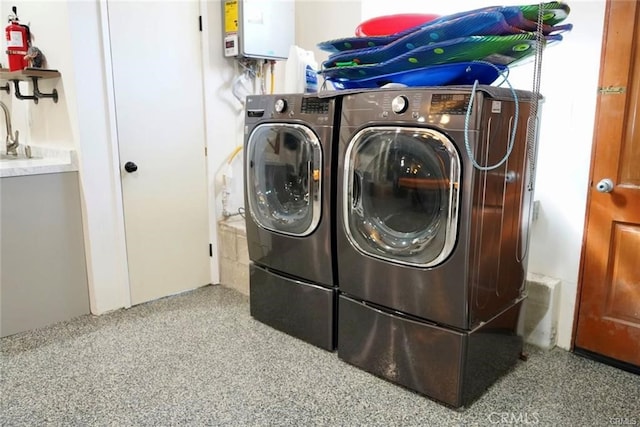 clothes washing area featuring washer and dryer