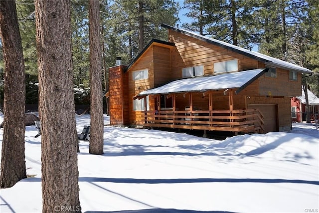 view of front facade featuring a garage and a wooden deck