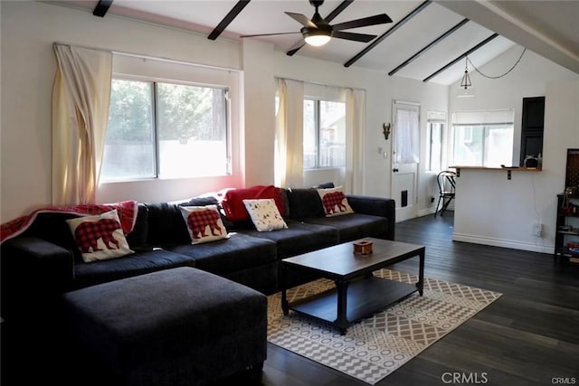 living room featuring vaulted ceiling, ceiling fan, dark wood-type flooring, and a wealth of natural light