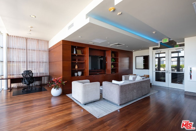 living room with dark hardwood / wood-style floors and french doors