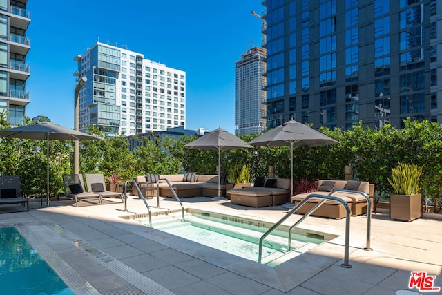 view of swimming pool featuring outdoor lounge area and a patio