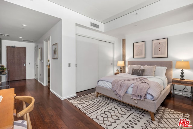 bedroom featuring a closet and dark hardwood / wood-style flooring