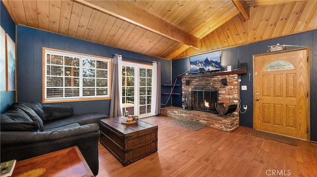 living room featuring wood ceiling, a brick fireplace, vaulted ceiling with beams, and hardwood / wood-style floors