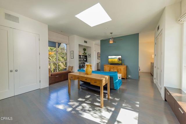 rec room with dark hardwood / wood-style floors, ceiling fan, and a skylight