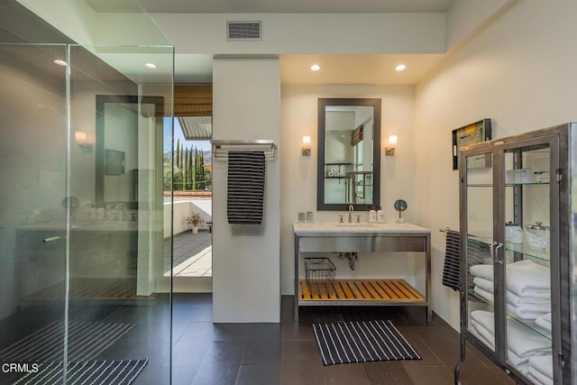 bathroom with vanity, tile patterned flooring, and a shower with shower door