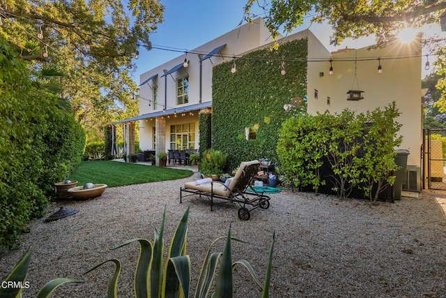 rear view of property featuring a yard and a patio area