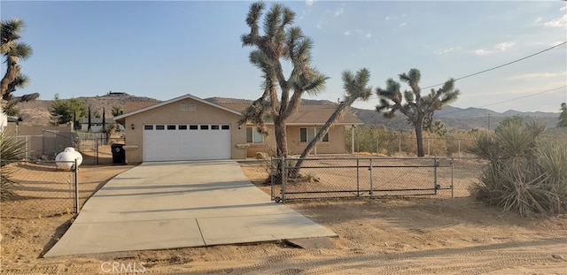 view of front of house with a garage and a mountain view