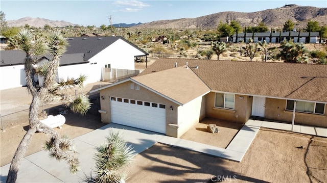 view of front facade with a mountain view and a garage