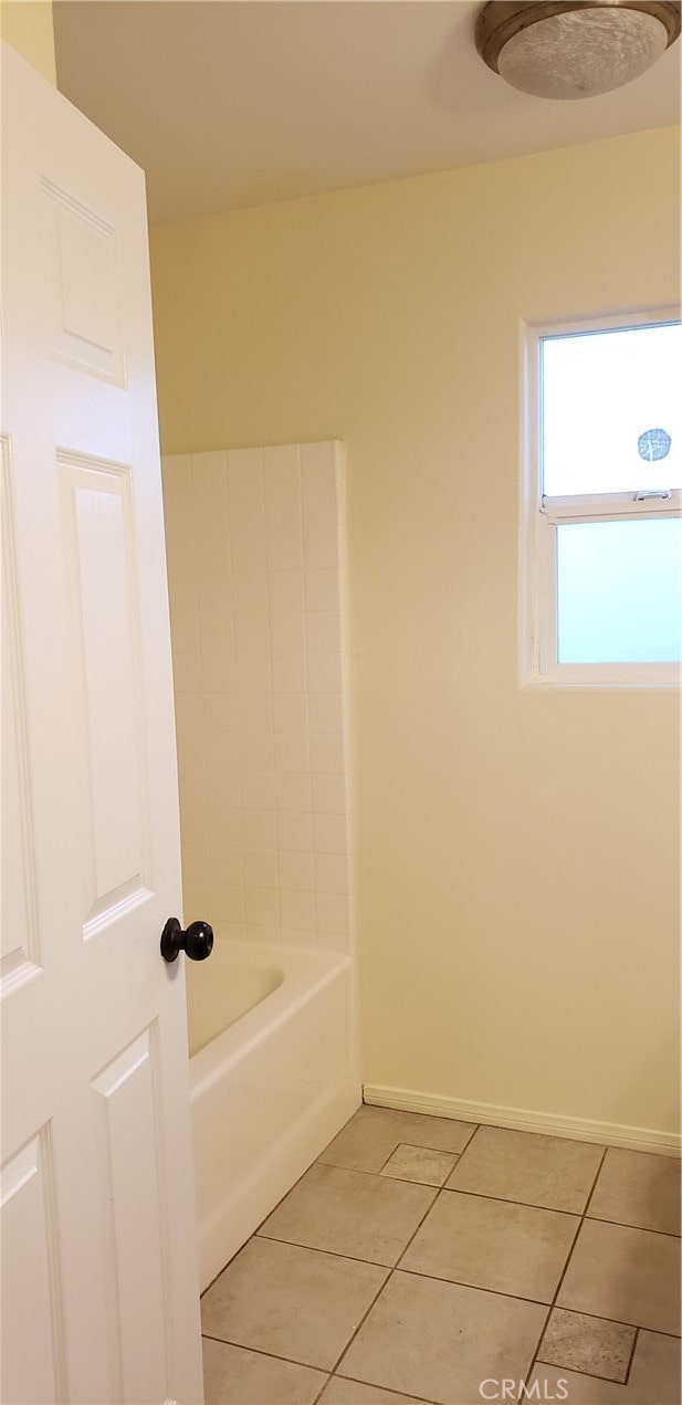 bathroom with  shower combination and tile patterned floors