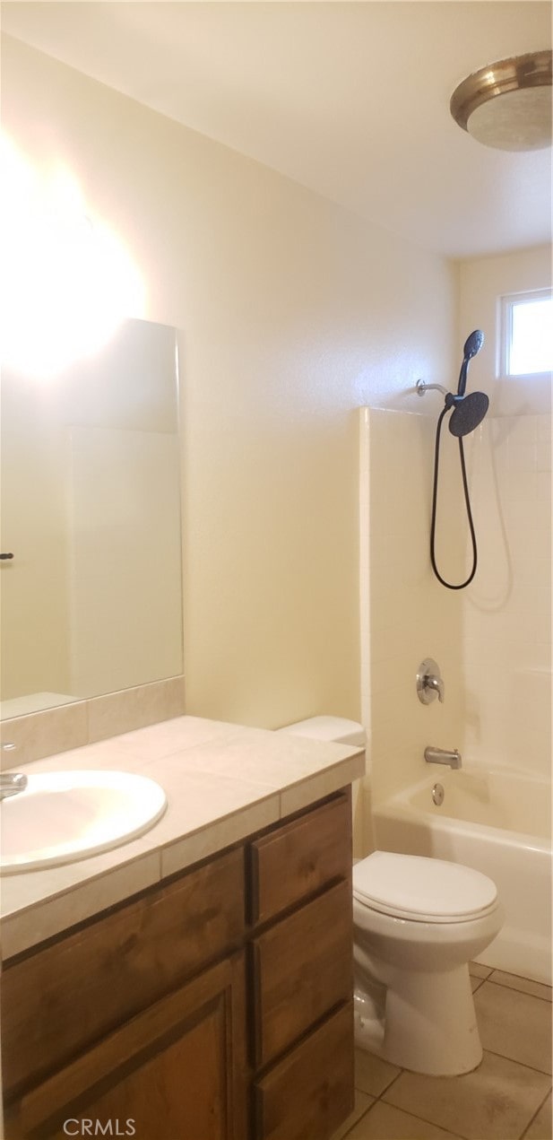 full bathroom featuring tile patterned floors, shower / washtub combination, vanity, and toilet