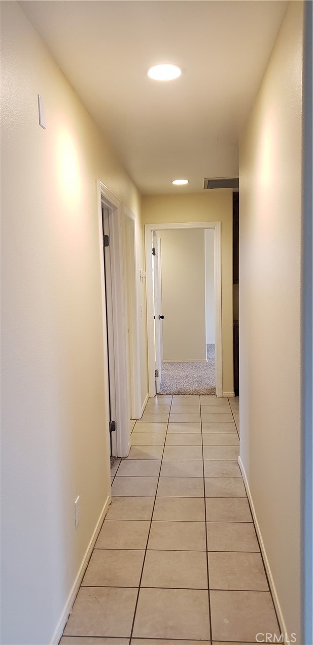 hall featuring light tile patterned floors