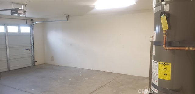 garage featuring strapped water heater and a garage door opener