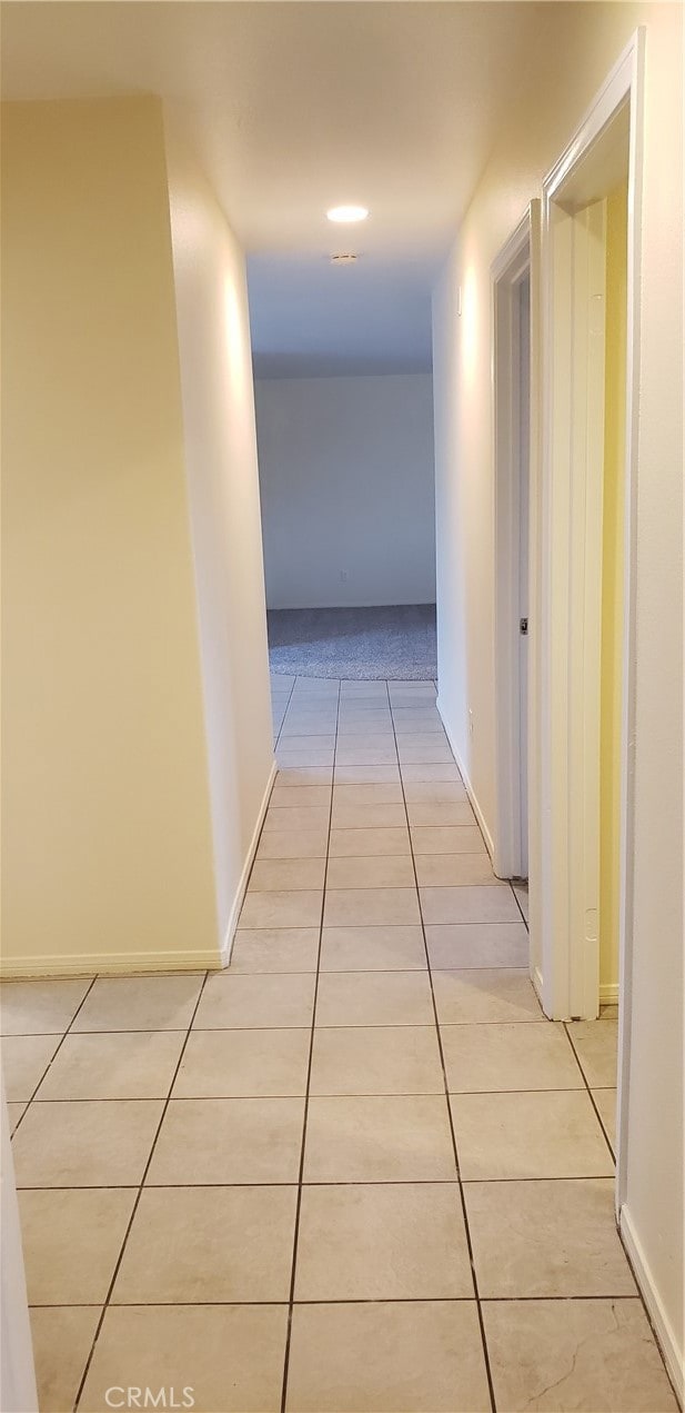 corridor with light tile patterned flooring