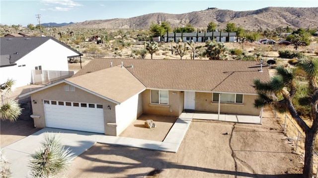 ranch-style house featuring a mountain view and a garage