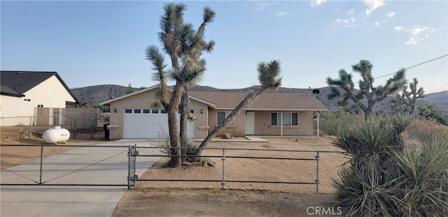 single story home featuring a garage and a mountain view