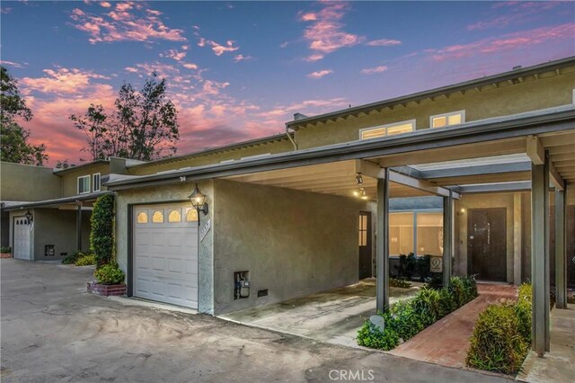 property exterior at dusk featuring a garage