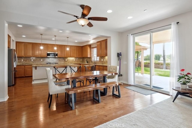 dining space with light wood-type flooring