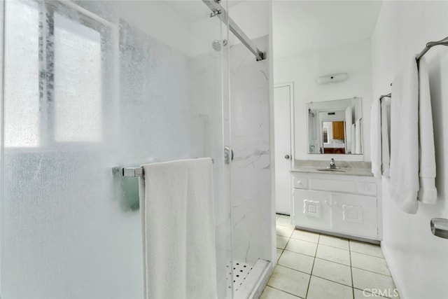 bathroom featuring vanity, tile patterned flooring, and a shower with door