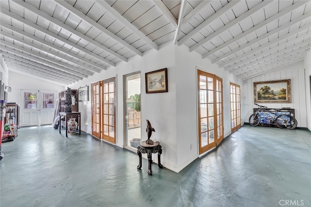 hallway with high vaulted ceiling, concrete floors, beamed ceiling, and french doors