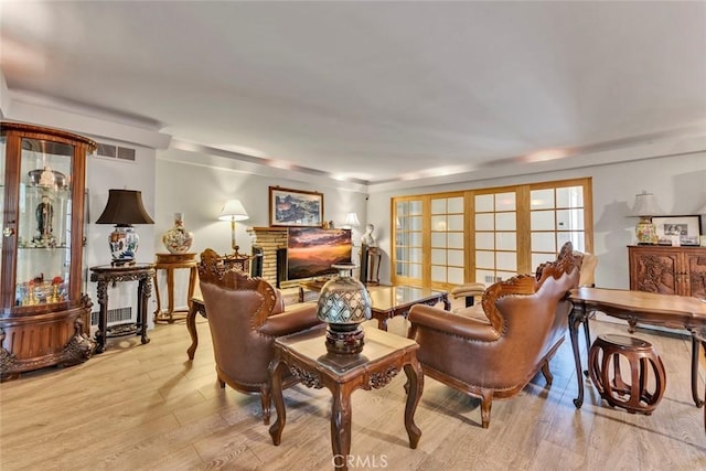 1021 S Lark Ellen Ave, West Covina, CA 91791 - living area featuring visible vents, light wood-style flooring, and a fireplace