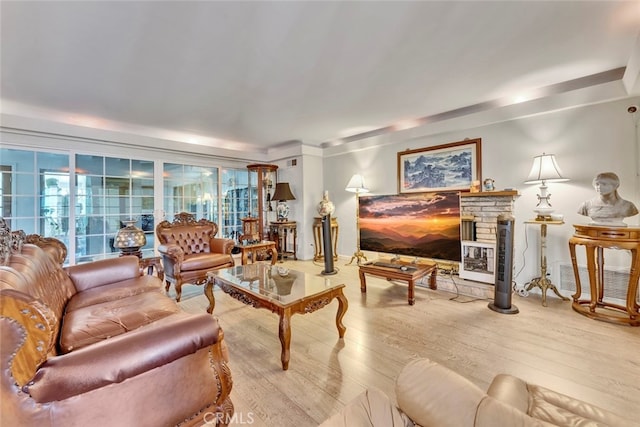 living room featuring wood-type flooring and a fireplace