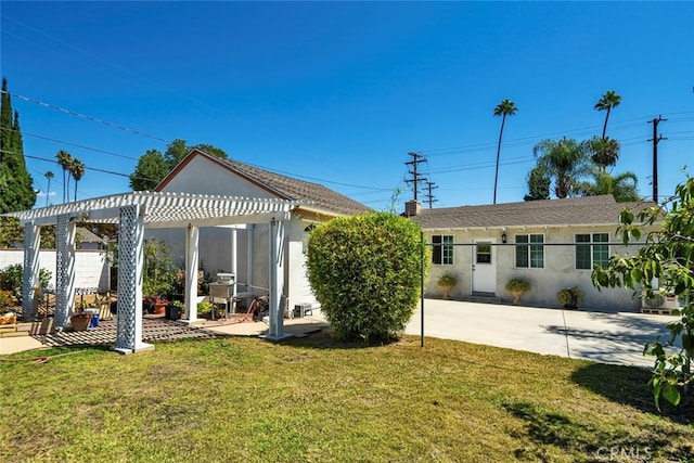 back of house featuring a yard, a pergola, and a patio