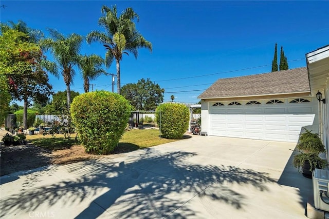 1021 S Lark Ellen Ave, West Covina, CA 91791 - exterior space featuring a shingled roof, a garage, and fence