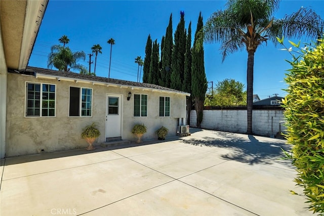 view of front of house with a patio and central AC unit