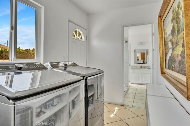 laundry room with light tile patterned floors and washing machine and clothes dryer